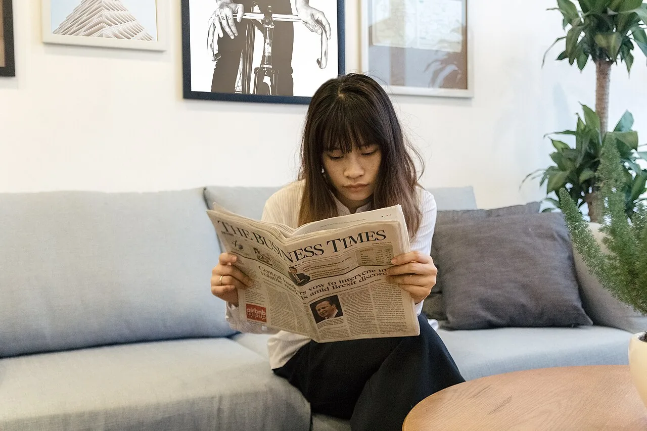 Business Woman is reading Newspaper - 35870943420